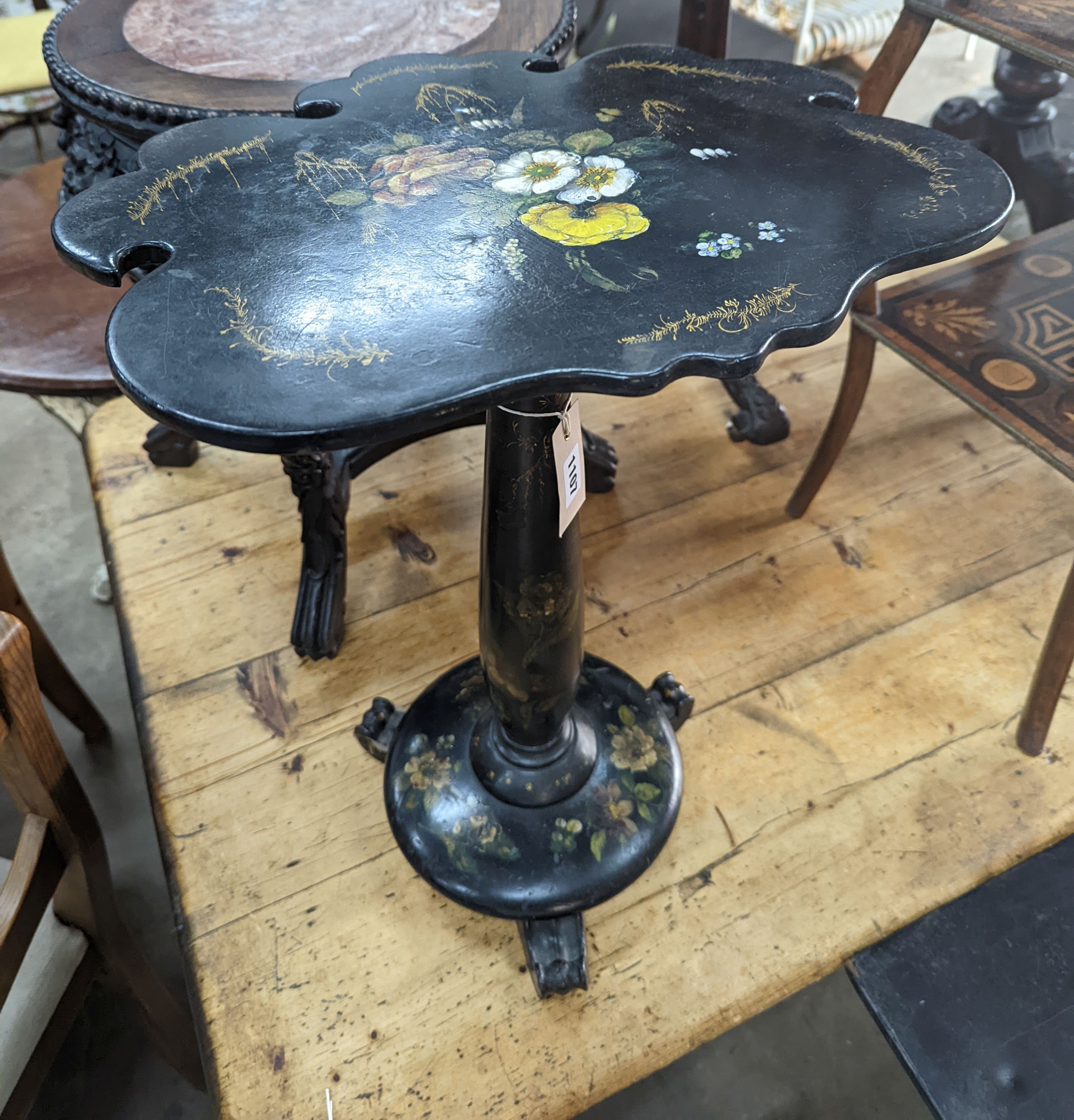 A Victorian floral painted papier mache occasional table, with a shaped oval top (converted from a pole screen), width 40cm, depth 33cm, height 53cm